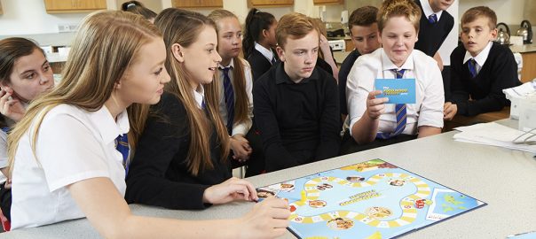 Secondary school pupils playing an educational board game